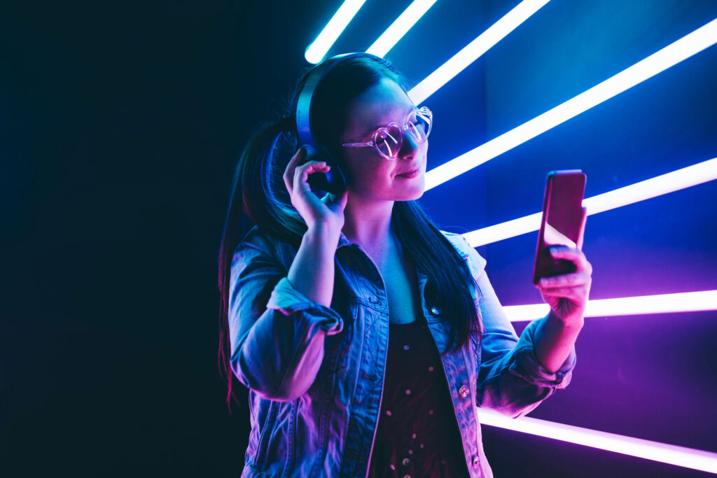 Young girl in denim jacket looking at smartphone